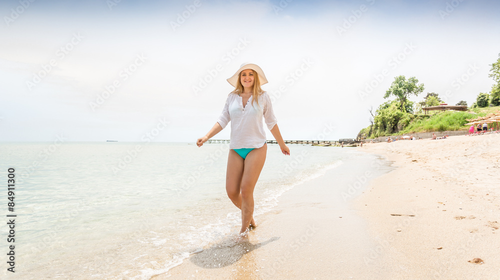 active woman walking on the sandy beach on island active woman walking on the sandy beach on island