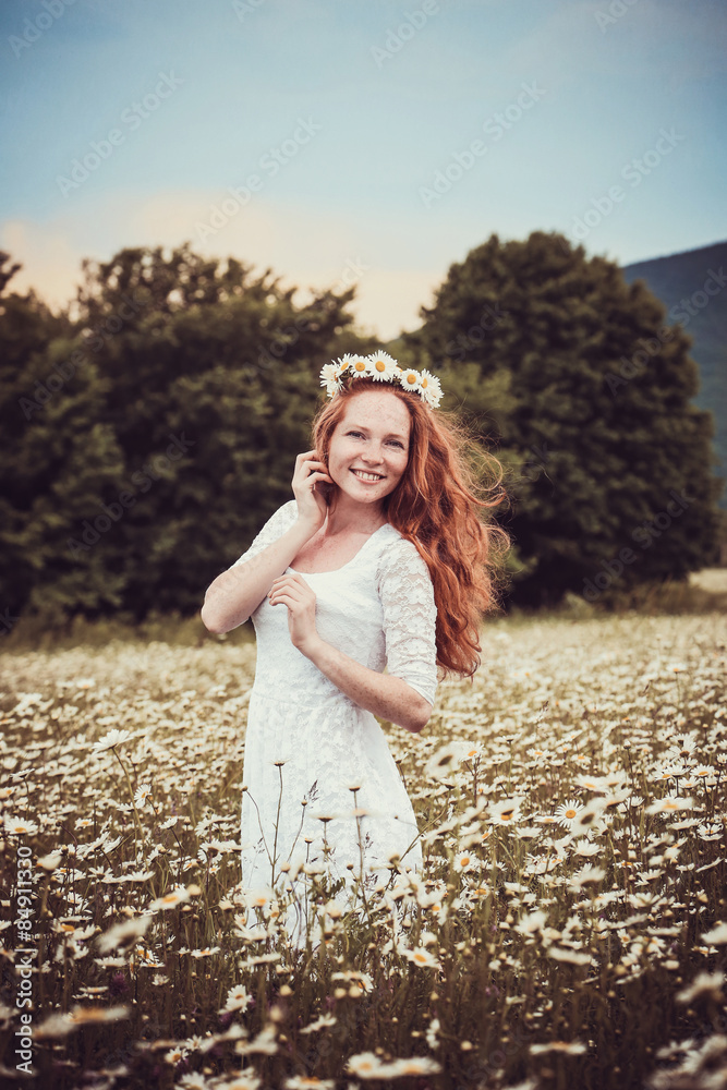 Image of pretty woman lying down on chamomile field, happy femal Image of pretty woman lying down on chamomile field, happy femal