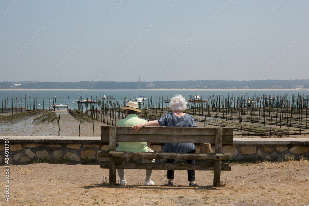 Couple sitting on the bench with their back to the camera Couple sitting on the bench with their back to the camera
