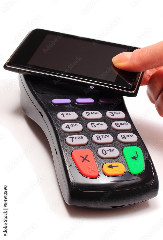 Hand of woman paying with NFC technology on mobile phone Hand of woman paying with NFC technology on mobile phone