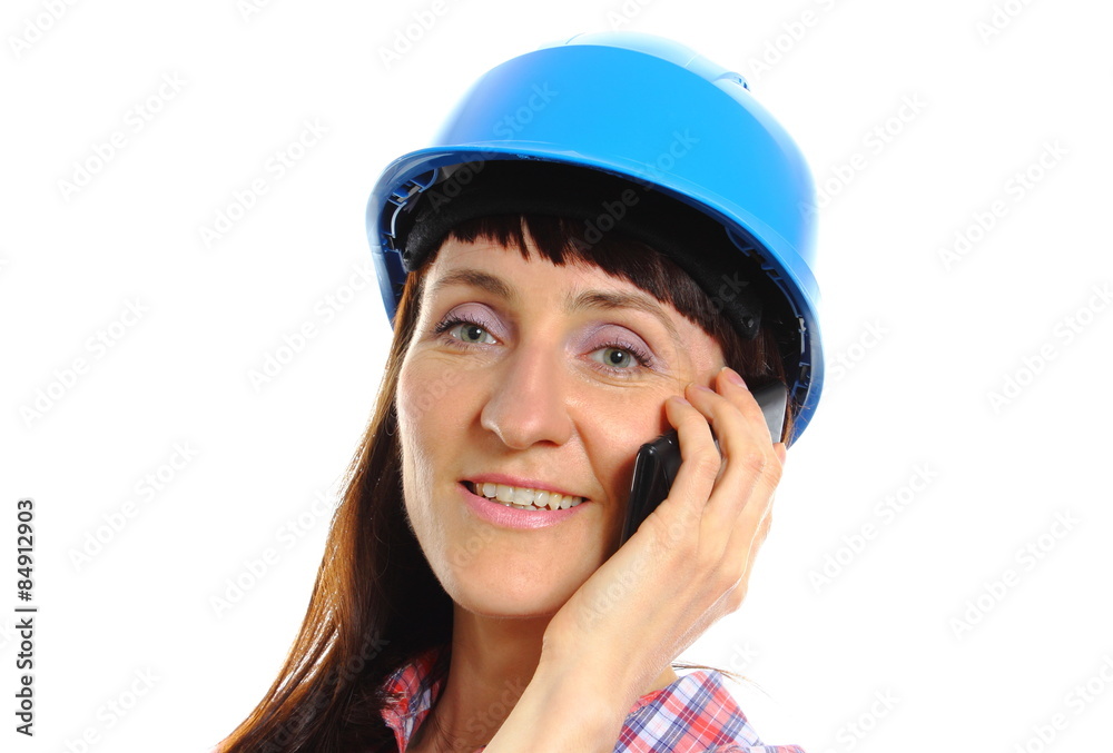 Builder woman in protective helmet talking on mobile phone Builder woman in protective helmet talking on mobile phone