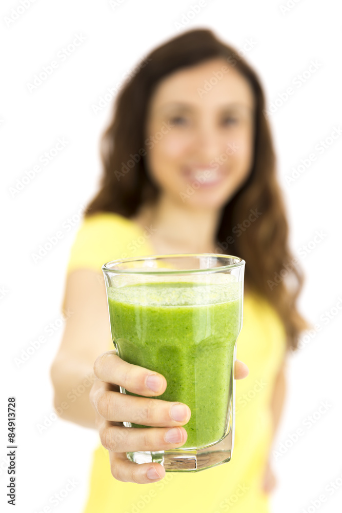 Girl showing a glass of green smoothie