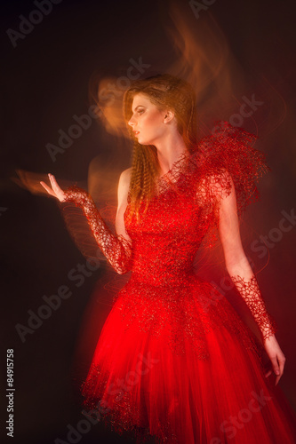 Beautiful fashionable woman in red dress photographed with mixed