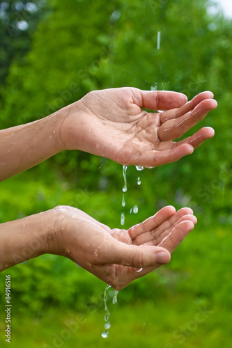 hands catching raindrops © rodimovpavel