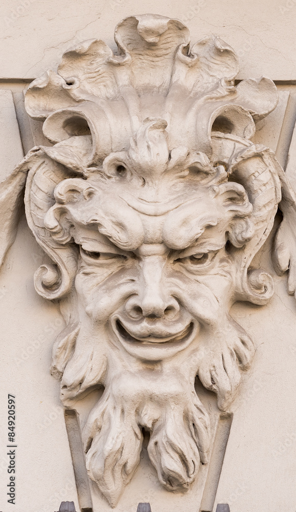 Diabolical mask on the exterior facade of a house in Augsburg (Germany)