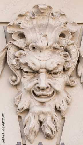 Diabolical mask on the exterior facade of a house in Augsburg (Germany)