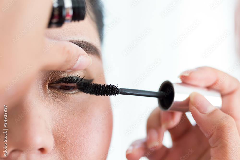 makeup artist used mascara brush with beautiful woman eyelashes - obrazy, fototapety, plakaty 