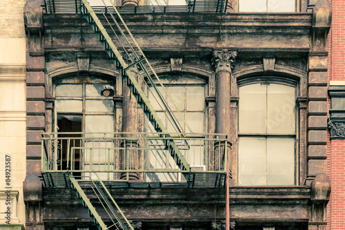 Canvas Print Windows and fire escape on  apartment building with vintage effect