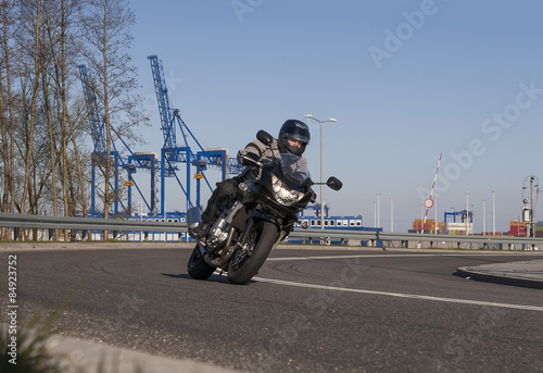 Motorcyclist riding along an asphalt road