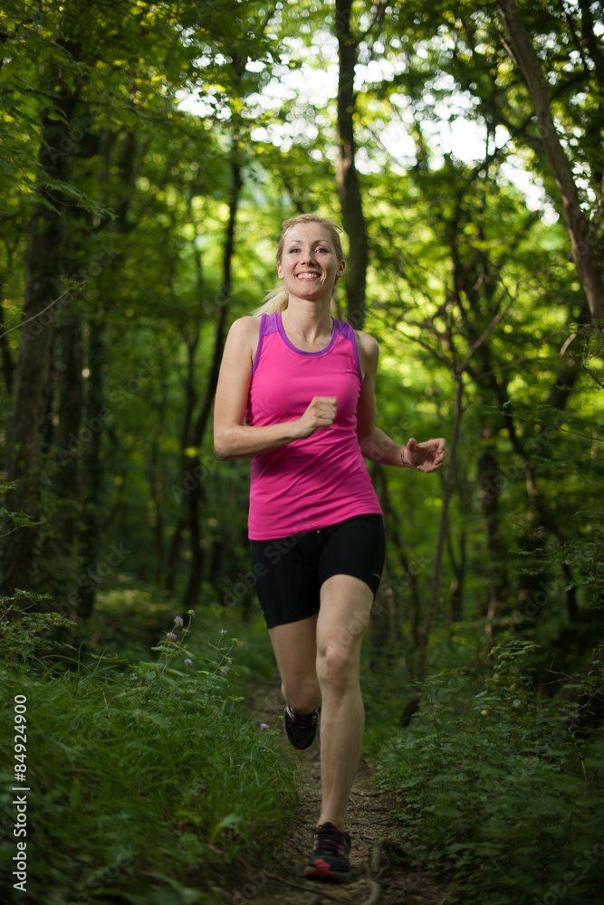Beautiful young woman runns on forest path Beautiful young woman runns on forest path