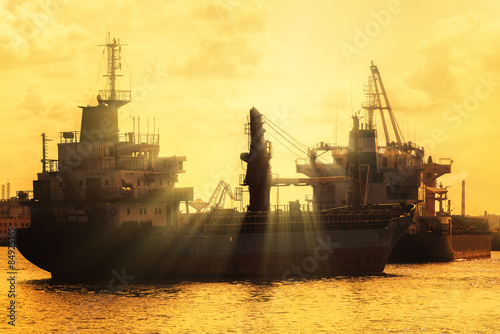 Commercial cargo ships at sunset
