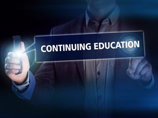 Businessman presses button continuing education on virtual scree