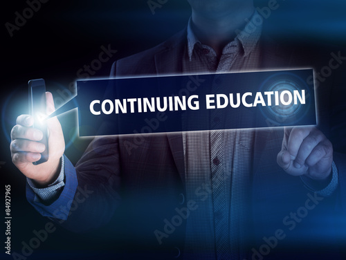 Quadro su tela Businessman presses button continuing education on virtual scree