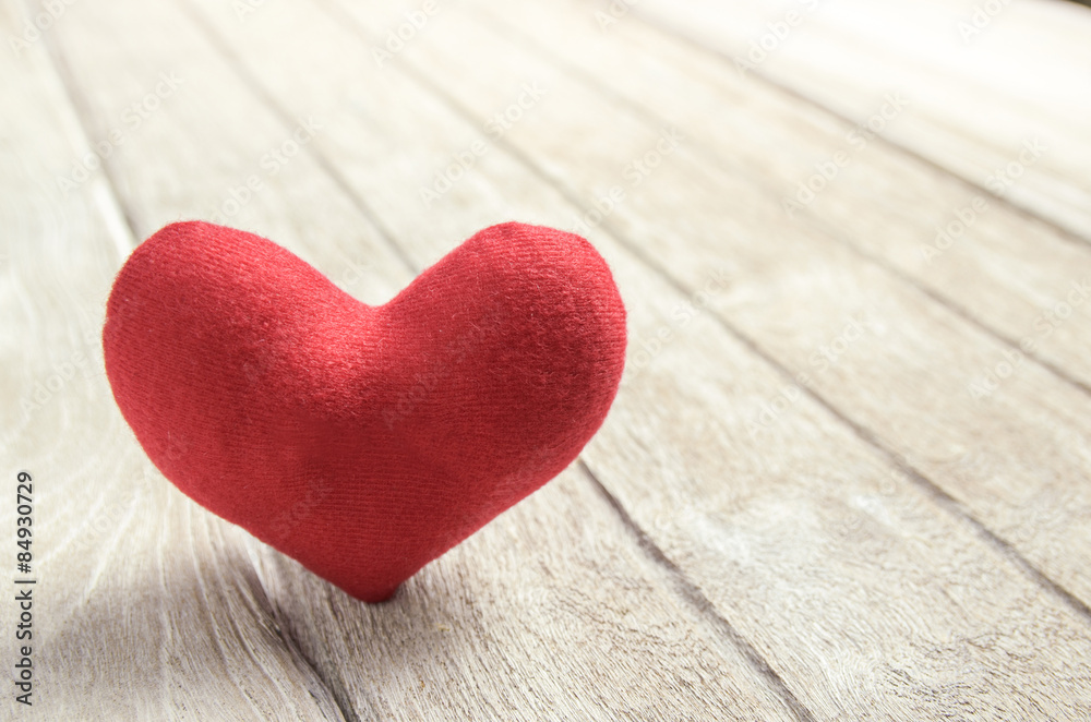 red heart shape on wood background red heart shape on wood background