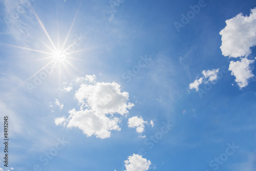 Blue sky and cloud with bright sun star flare background.