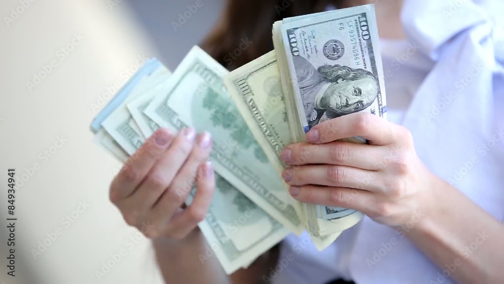 Business woman counts the money