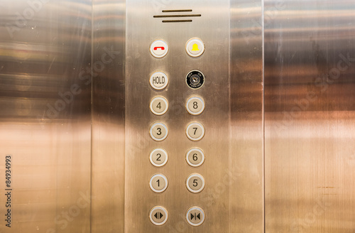 Stainless steel elevator panel push buttons.