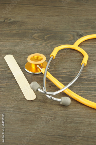 Wooden tongue depressor and stethoscope