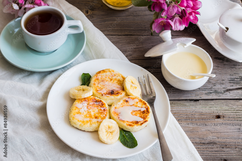 curd cheese pancakes with banana, condensed milk and fresh mint,