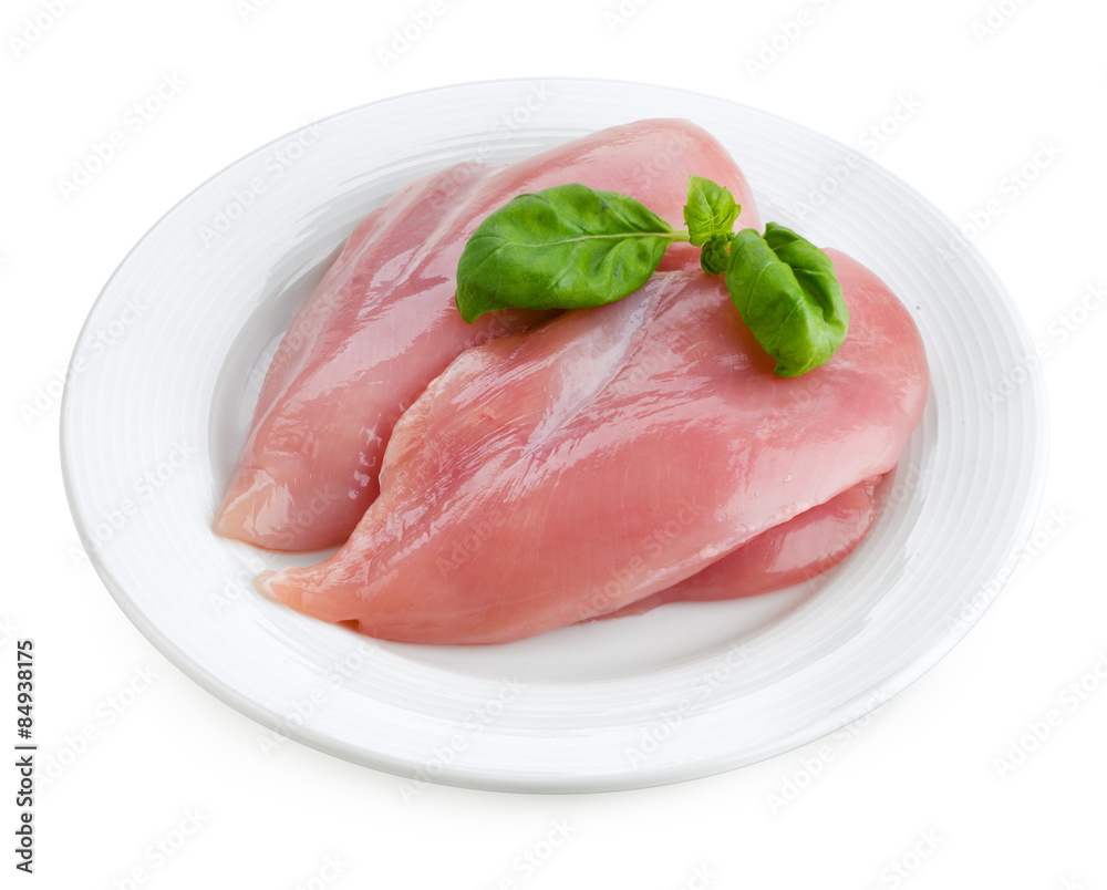 Raw fresh chicken fillet with basil isolated on white plate.