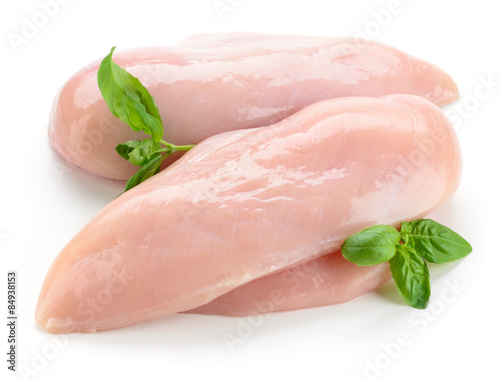 Raw chicken fillets with basil isolated on white