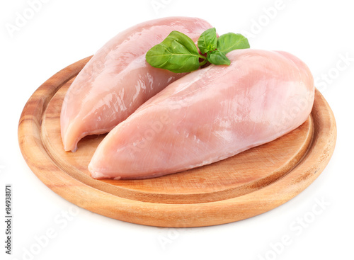 Tablou canvas Raw chicken fillets on wooden board isolated on white