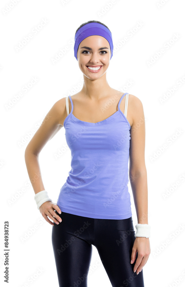 smiling sporty brunette woman in violet sportswear, isolated