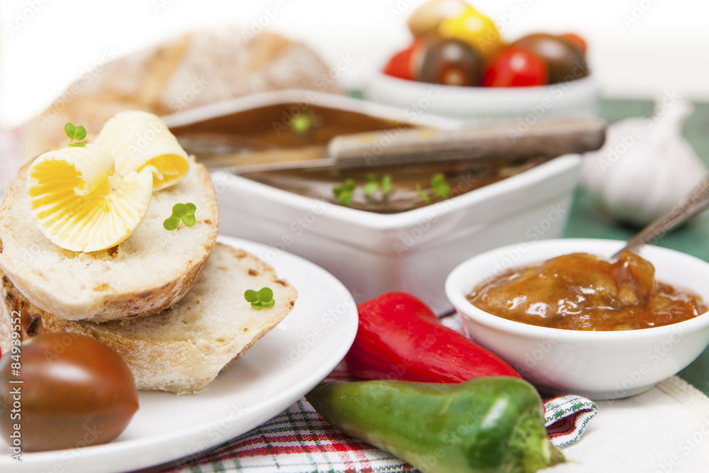 Slices of bread and butter with tomatoes, peppers, chutney and p Slices of bread and butter with tomatoes, peppers, chutney and p