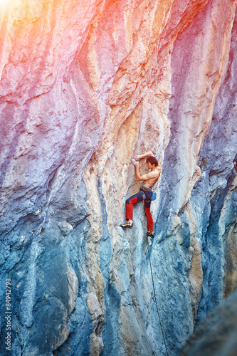 Rock climber climbing up a cliff © vitaliymateha