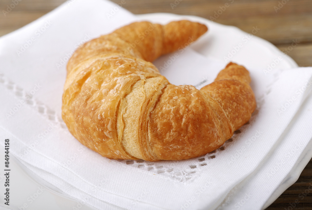 Golden croissant on a plate
