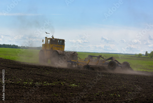 Tractor plowing a field © faustasyan