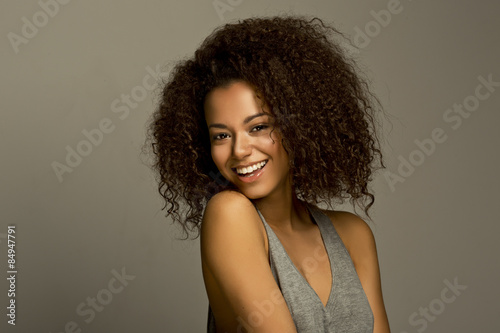 Portrait of a beautiful natural young African woman smiling happiness