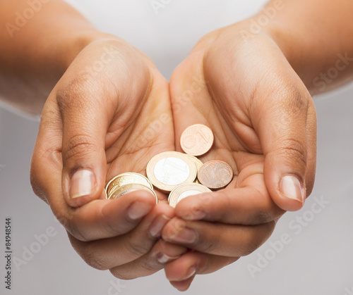 womans cupped hands showing euro coins