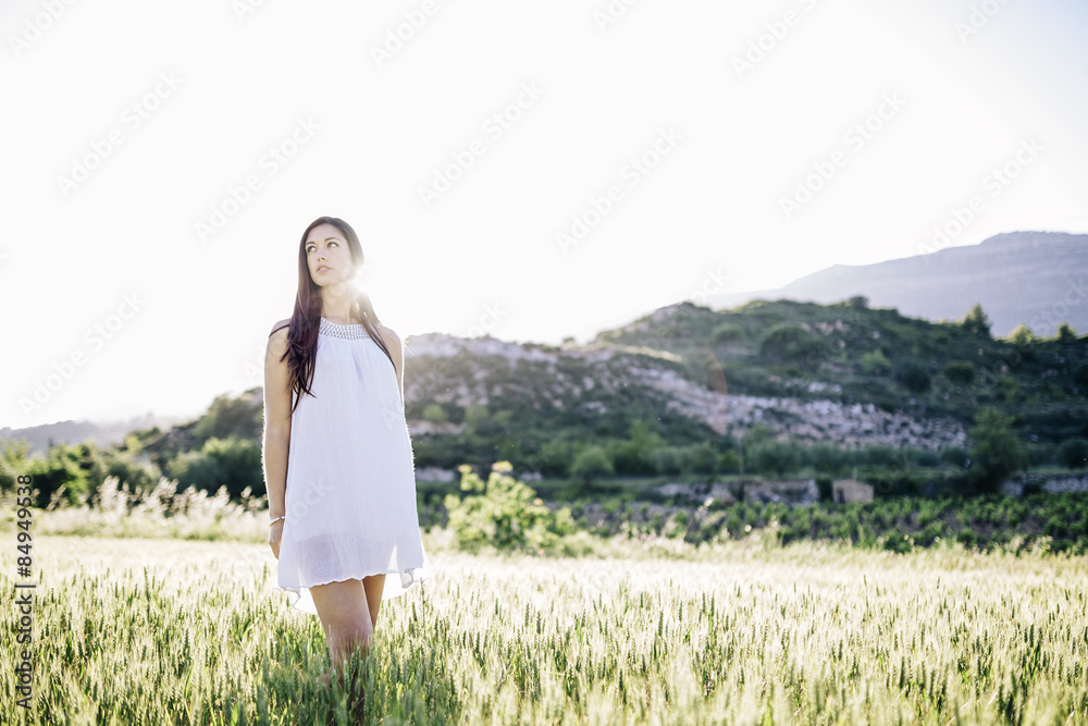 Happy young woman in a dress on the field Happy young woman in a dress on the field