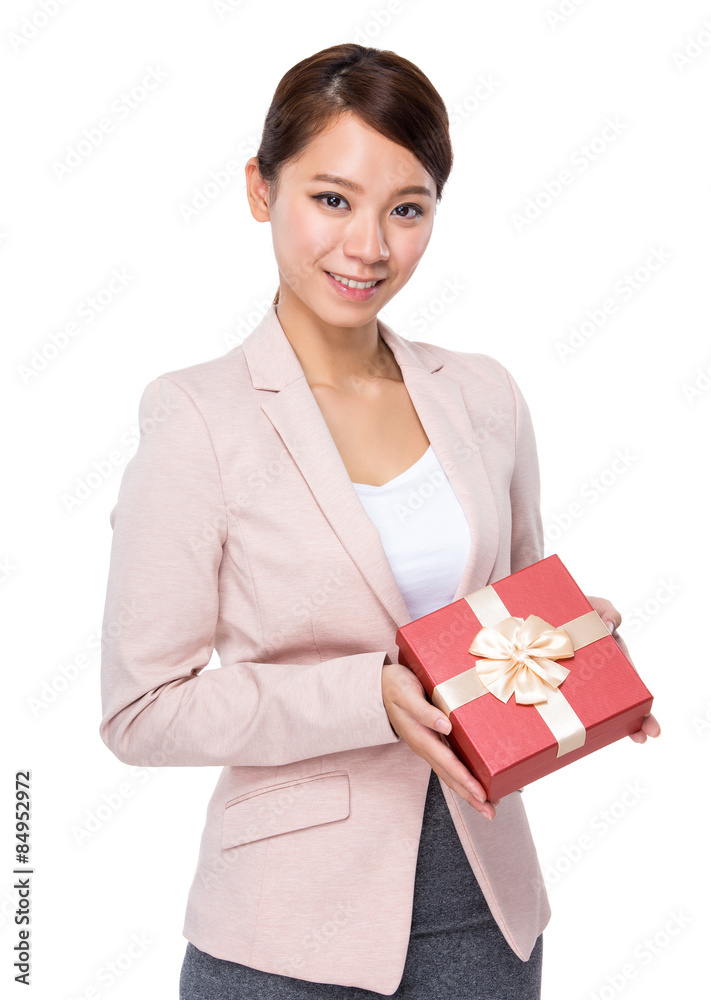 Asian businesswoman holding a giftbox to client Asian businesswoman holding a giftbox to client