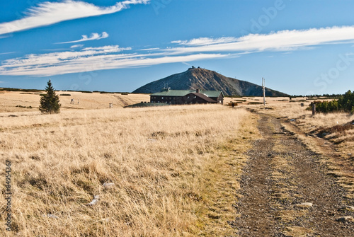 meadows, Lucni bouda chalet and Snezka hill on the background in autumn Krkonose mountains