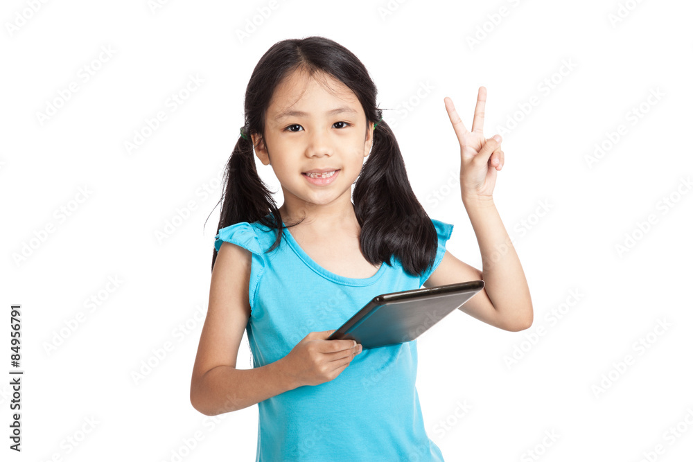Little asian girl show victory sign with tablet pc Little asian girl show victory sign with tablet pc