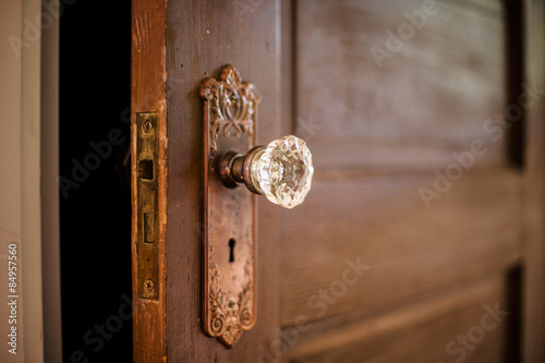 Wooded door with antique door knob. 