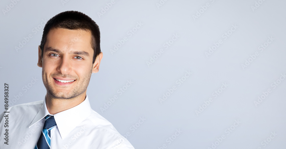 Portrait of cheerful businessman, against grey Portrait of cheerful businessman, against grey