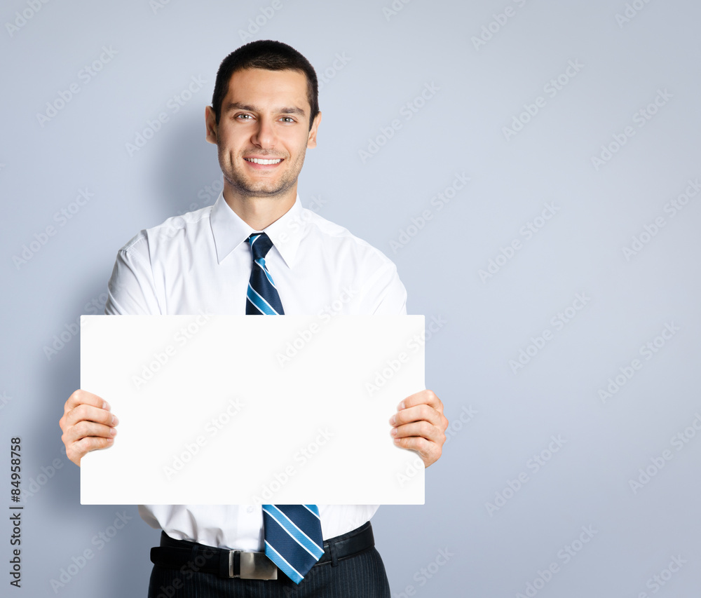 Businessman showing blank sign board, with copyspace Businessman showing blank sign board, with copyspace