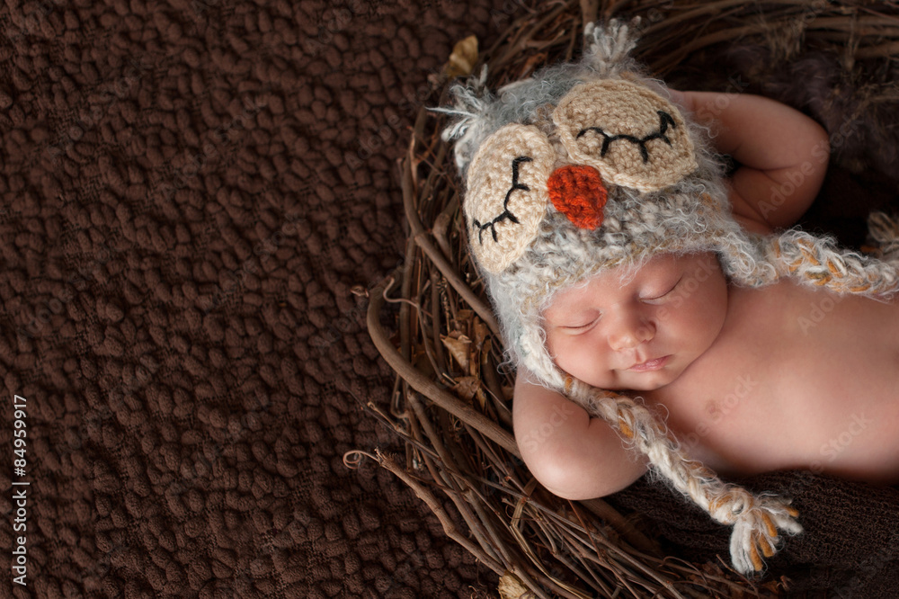 Smiling Newborn Baby Boy Wearing an Owl Hat Smiling Newborn Baby Boy Wearing an Owl Hat