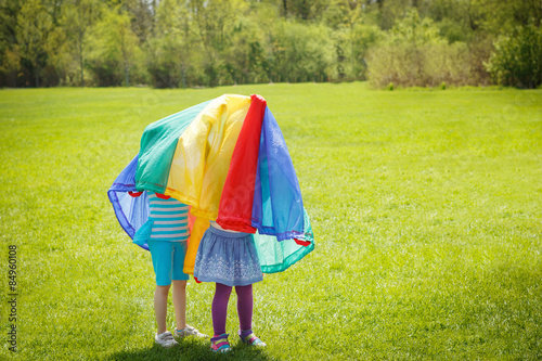 children girls under parachute
