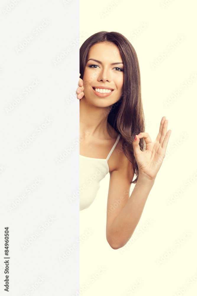 Woman showing okay gesture, over empty blank signboard