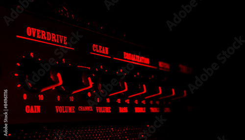 guitar amplifier control panel in red light photo