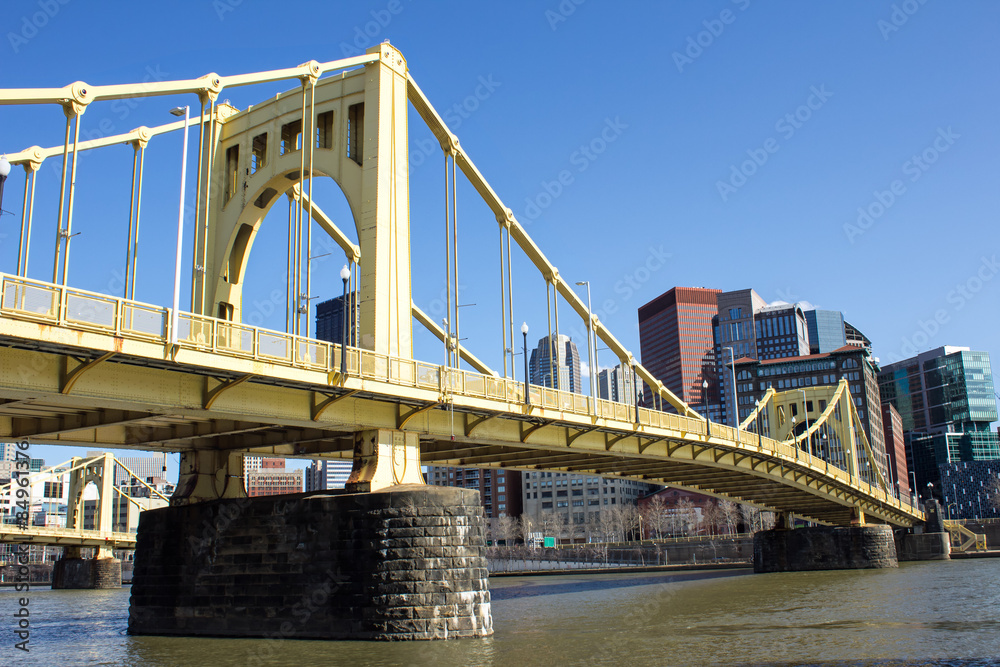 Yellow Bridge On Stone Supports - Side Views of a Yellow Painted Iron Suspension Bridge Across the Allegheny River Toward Downtown Pittsburgh Pennsylvania Yellow Bridge On Stone Supports - Side Views of a Yellow Painted Iron Suspension Bridge Across the Allegheny River Toward Downtown Pittsburgh Pennsylvania
