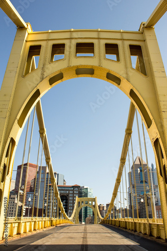 Yellow Bridge Center - Yellow Painted Iron Bridge and Empty Road Leads Into a City of Tall Buildings