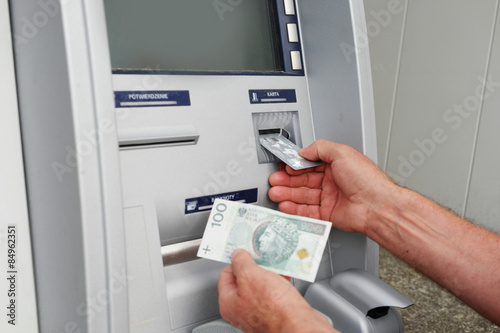 hand of a man using banking machine