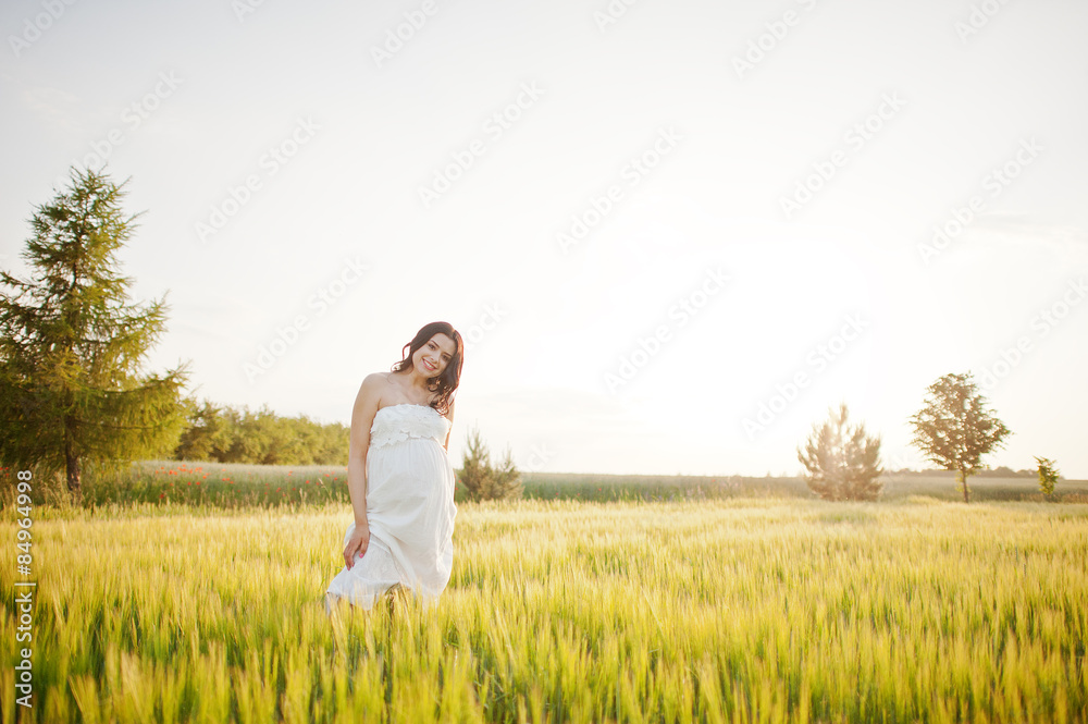 pregnant gorgeous brunette woman on the field with wheat and pop pregnant gorgeous brunette woman on the field with wheat and pop