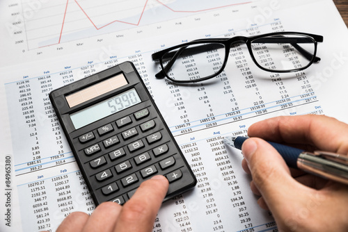 Businessman Calculating Financial Sheet