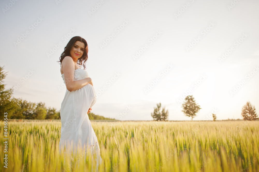 pregnant gorgeous brunette woman on the field with wheat and pop pregnant gorgeous brunette woman on the field with wheat and pop